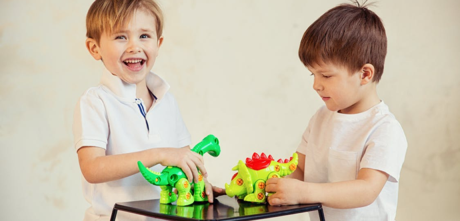 boys playing with dinosaur toys
