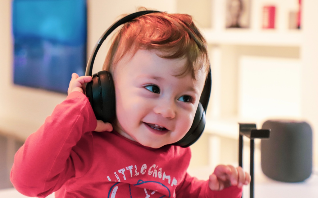 Little kid listening to music with headphones on