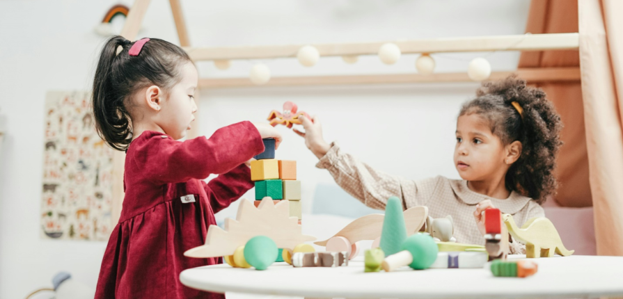 Kids playing with building blocks in a preschool.