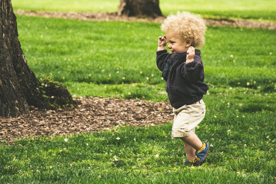 A toddler running in a park
